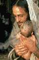 Jesus holding baby against his chest